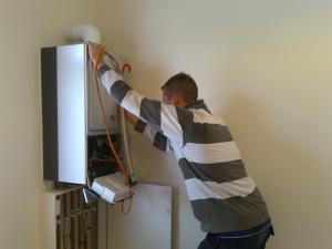 an El Cerrito plumber is inspecting a water heater